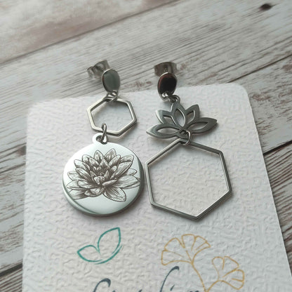 Paire de boucles d'oreilles asymétriques lotus en acier inoxydable portée par une femme, finition miroir.