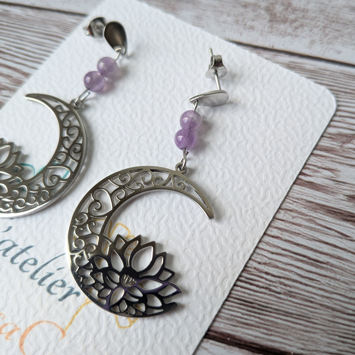 Gros plan sur le motif lune et lotus argenté avec des perles naturelles.