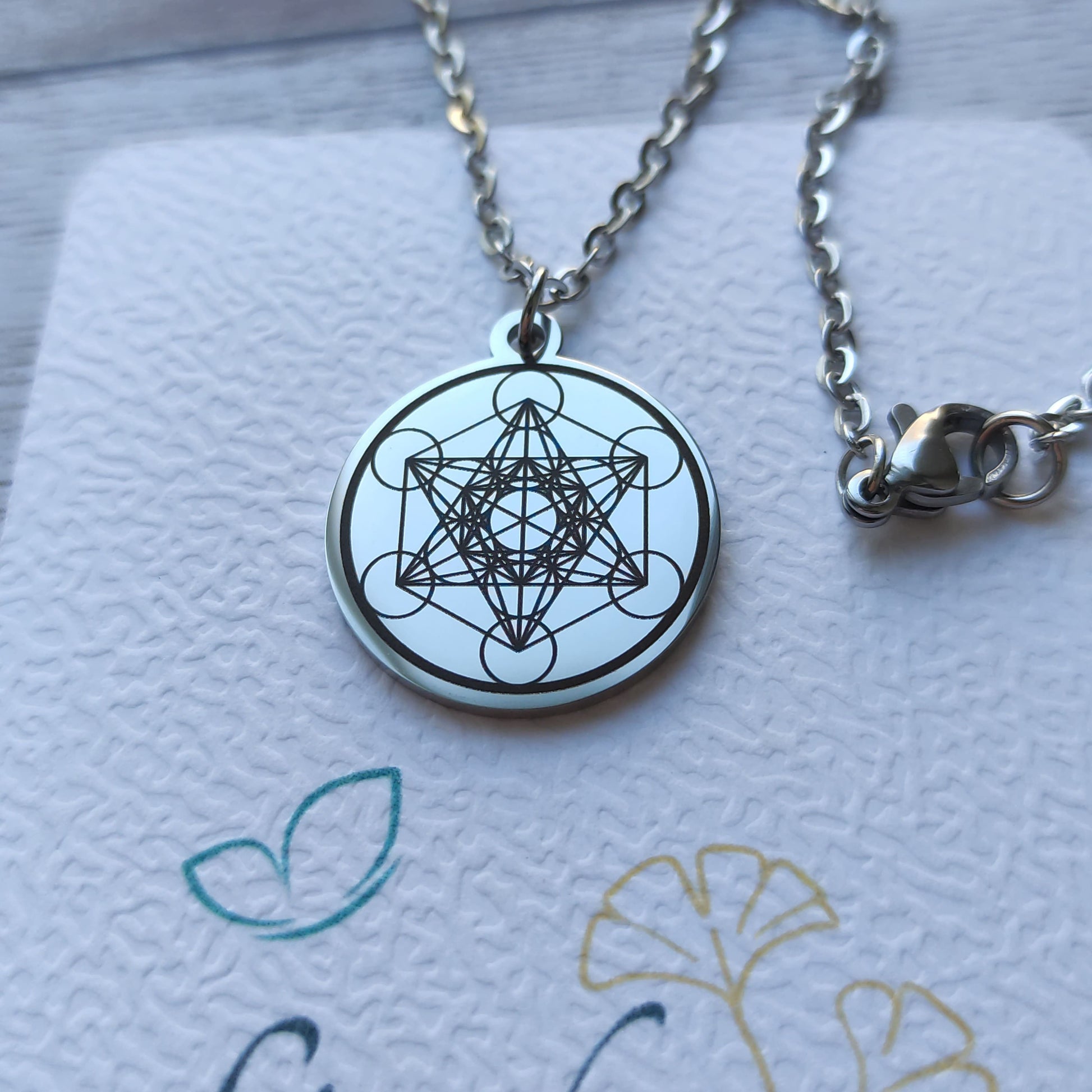 Pendentif rond acier poli miroir avec gravure Cube de Métatron.