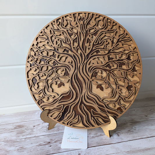 Décoration murale ronde Arbre de Vie en bois de tilleul, finition artisanale au brou de noix, présentée sur un chevalet en bois.