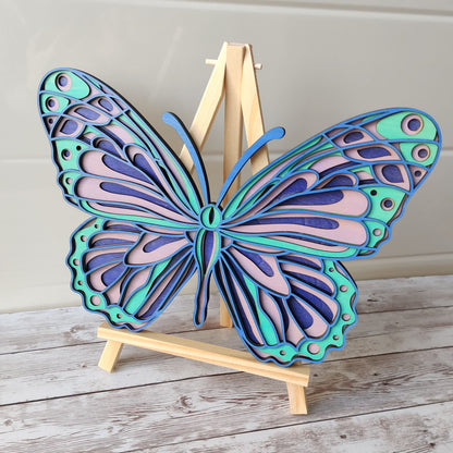 Décoration murale papillon en bois 4 couches, aux teintes bleu, turquoise et violet, création artisanale Vanessa Créa.
