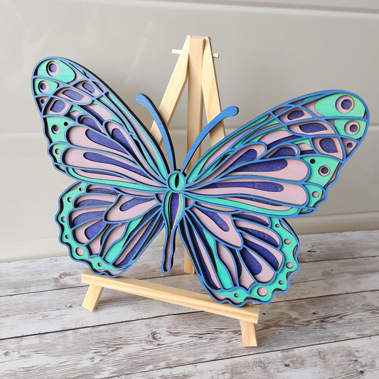 Décoration murale papillon en bois 4 couches, aux teintes bleu, turquoise et violet, création artisanale Vanessa Créa.