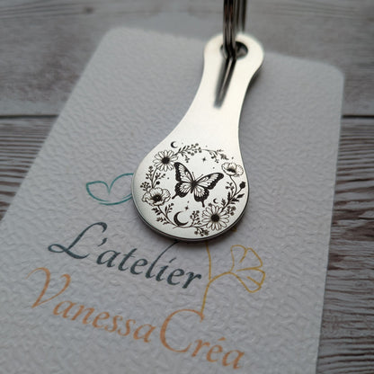 Porte-clés jeton de caddie en acier inoxydable gravé d'un papillon entouré d'une couronne de feuilles et de fleurs, L'Atelier VanessaCréa.